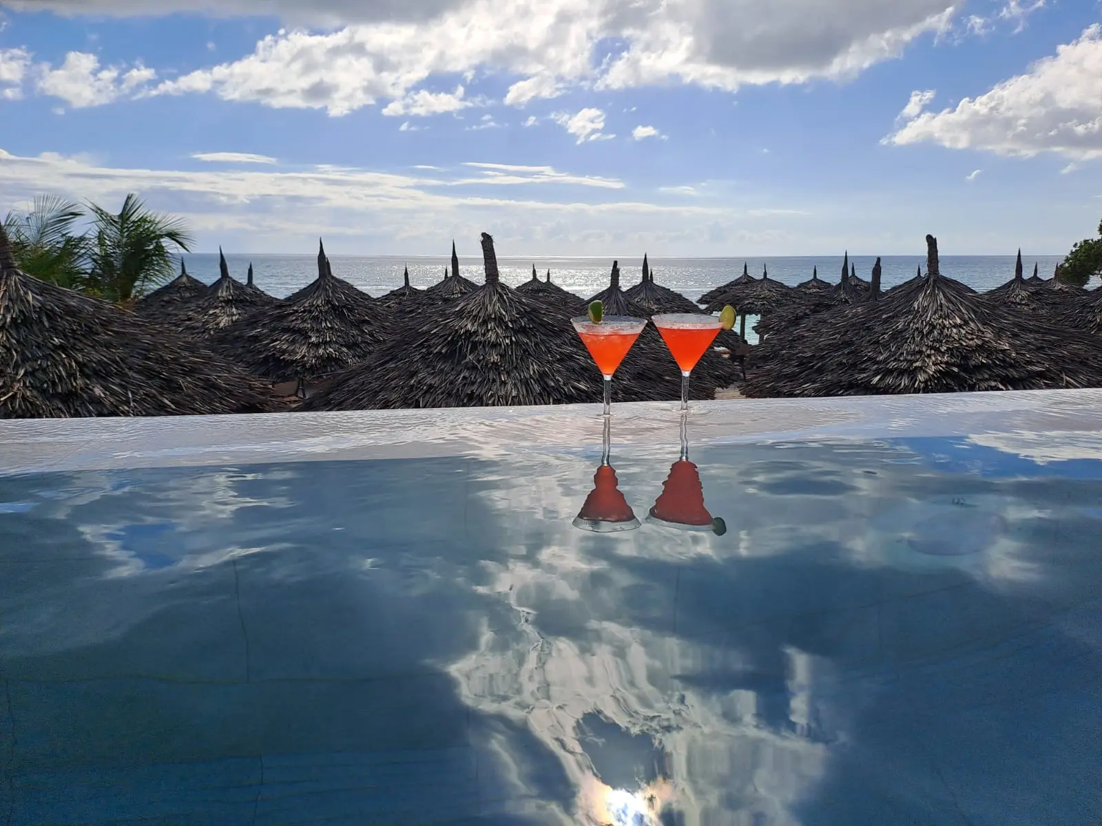 Two cocktails overlooking the ocean from the swim-up bar pool